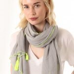 Scarf With Tassels at ark vintage. A plain cotton scarf with a tassel detail at each corner. This lightweight design can also be worn alternatively as a sarong. Available in 2 colours: blue with a neon coral stitching and grey with neon yellow stitching. msh shop buy online in store camberley surrey