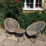 Garden furniture. 2 Chairs and and a table. Beautiful grey/green faux rattan set. See picture for detail. These look absolutely stunning and are also fantastic quality which is made to last! The chairs and table fold to enable storage when not in use. Camber